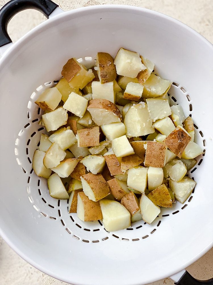 process shot showing potatoes in colander