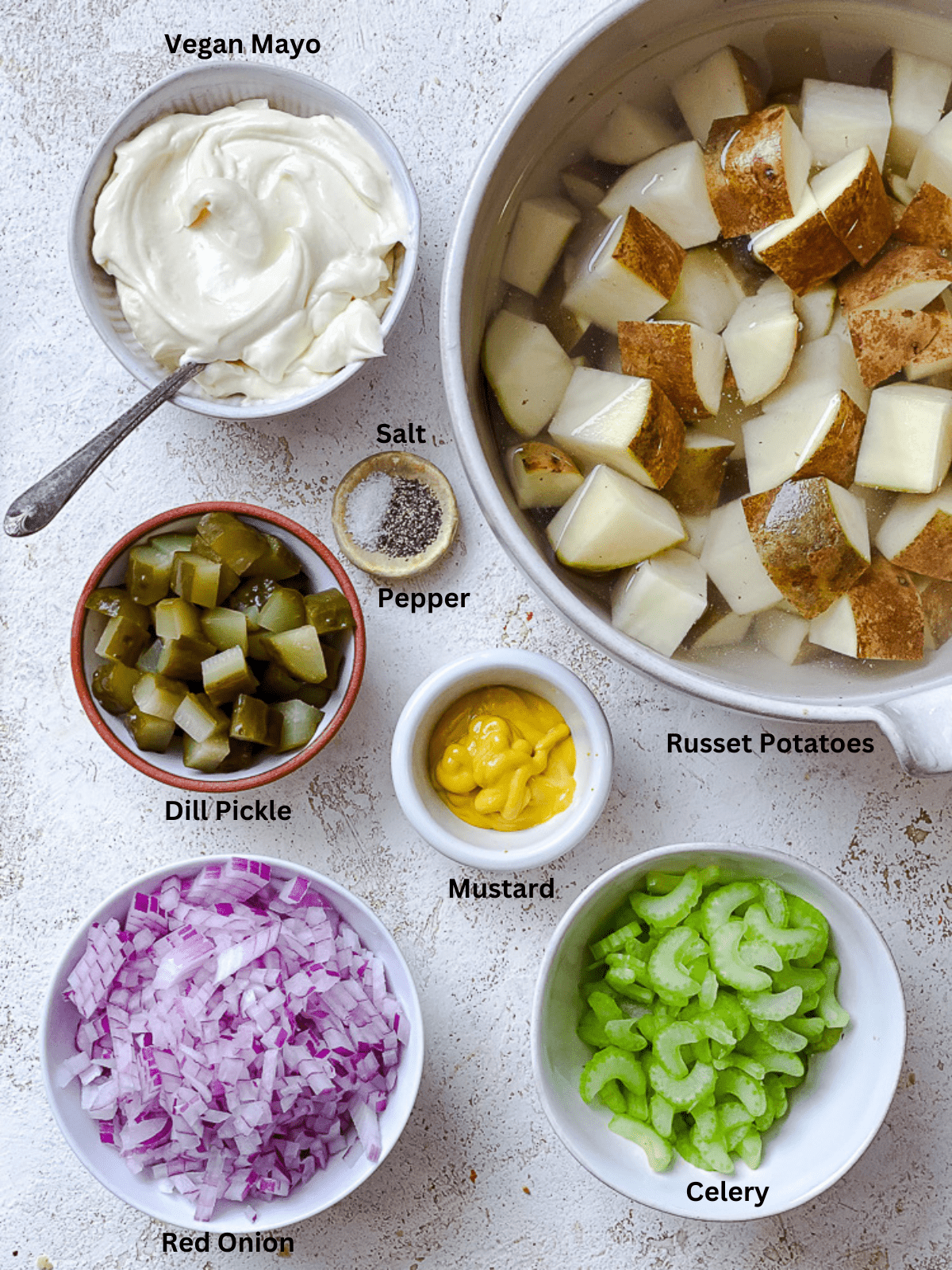 ingredients for Easy Vegan Potato Salad measured out on a white surface