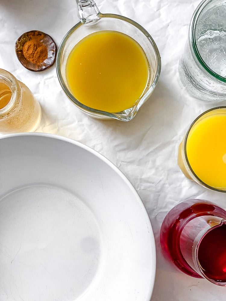 ingredients for Non-Alcoholic Thanksgiving Punch measured out on a white surface