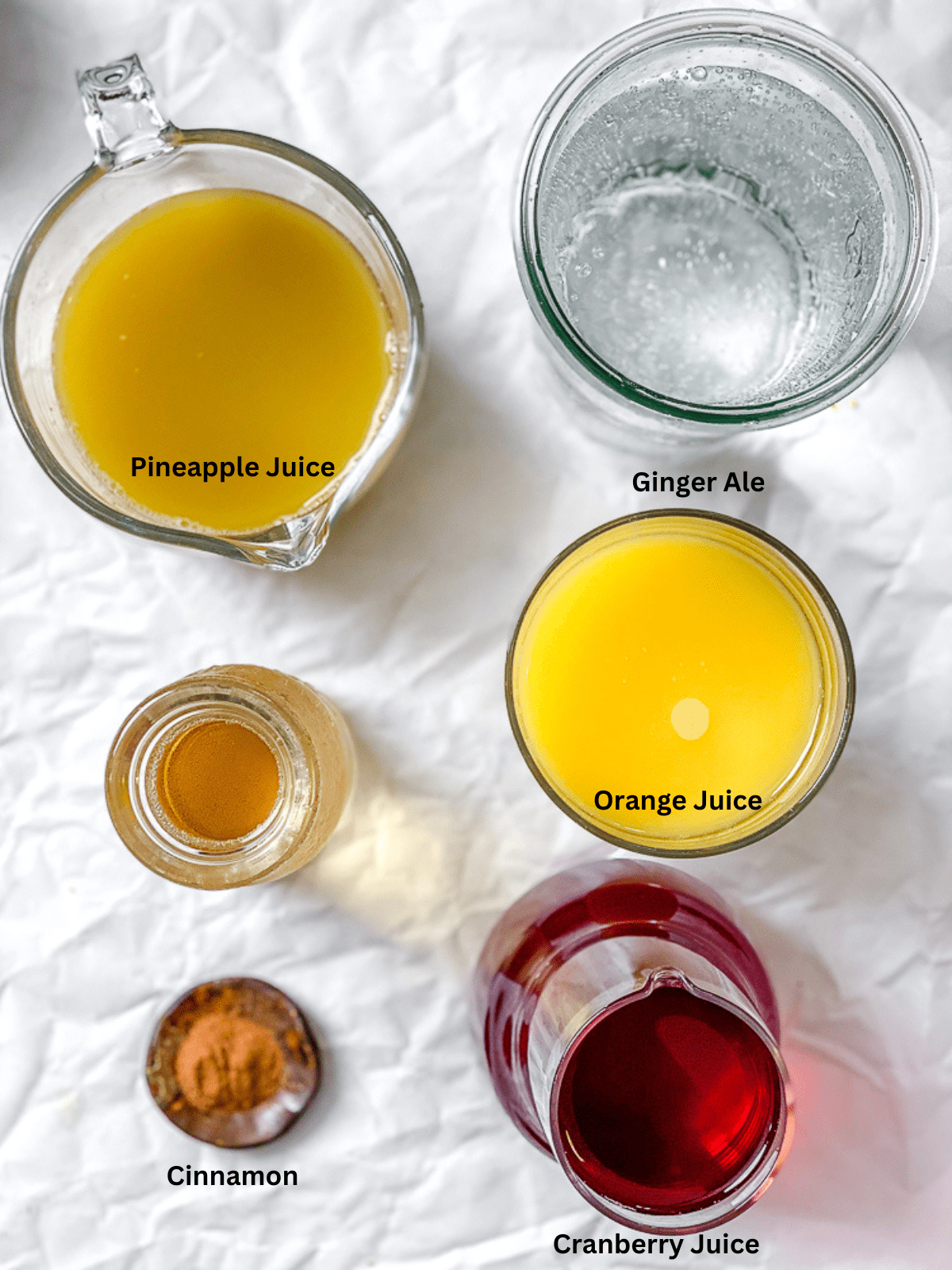 ingredients for Non-Alcoholic Thanksgiving Punch measured out on a white surface