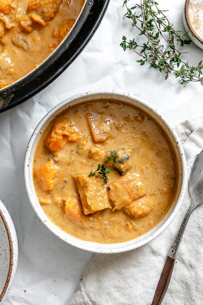 completed Sweet Potato Pumpkin Soup in a bowl alongside pot