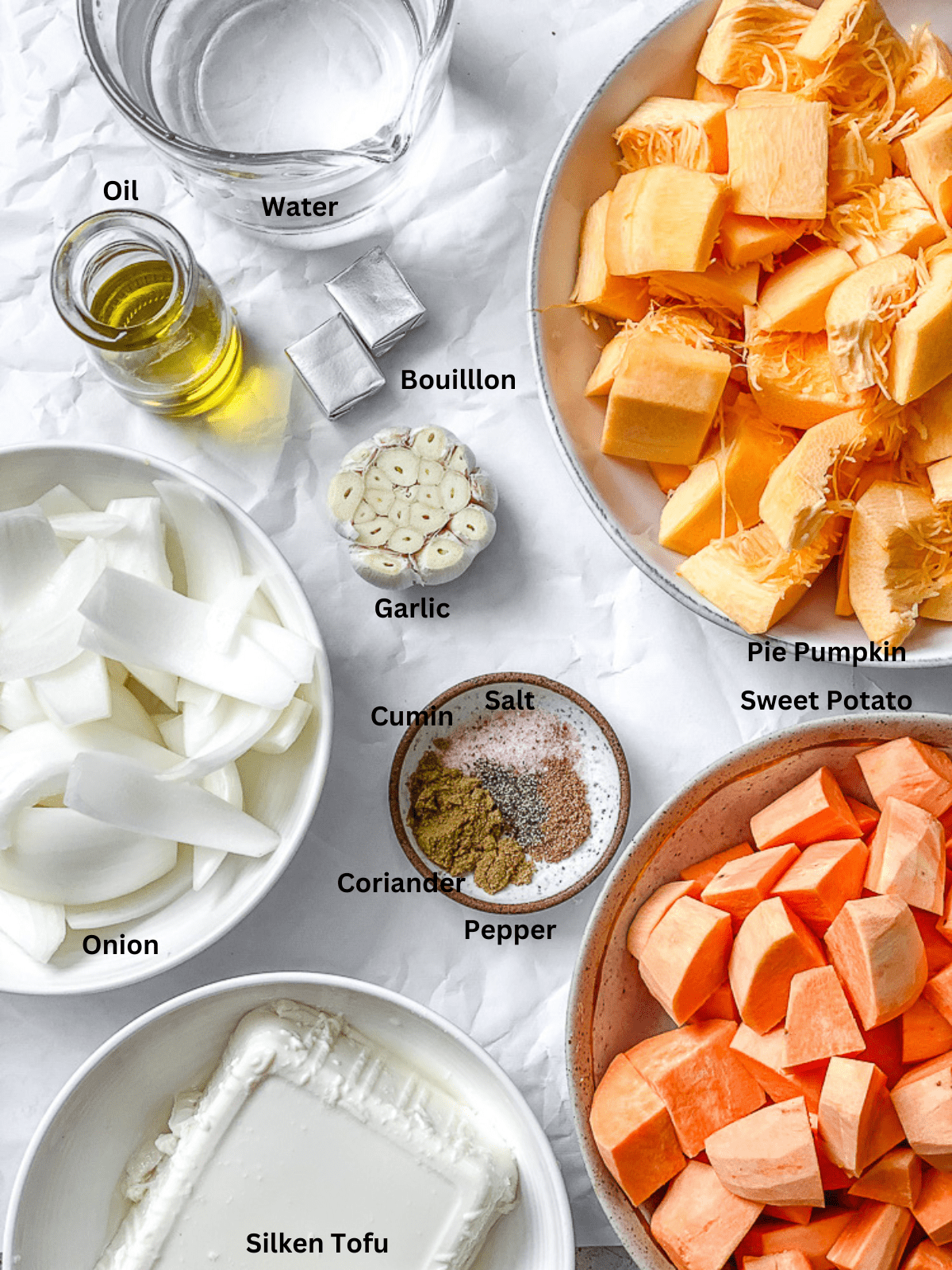 ingredients for Sweet Potato Pumpkin Soup measured out on a white surface