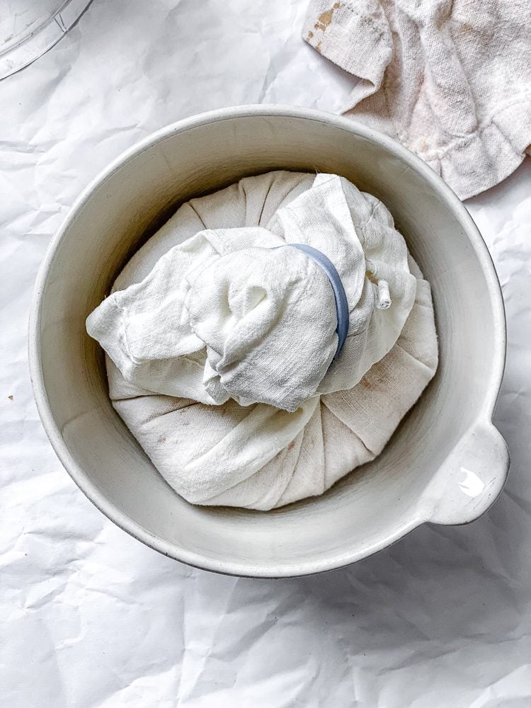 process shot showing vegan cheese ball in a towel