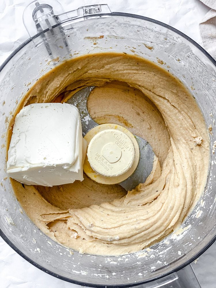 process shot showing vegan cream cheese added to food processor