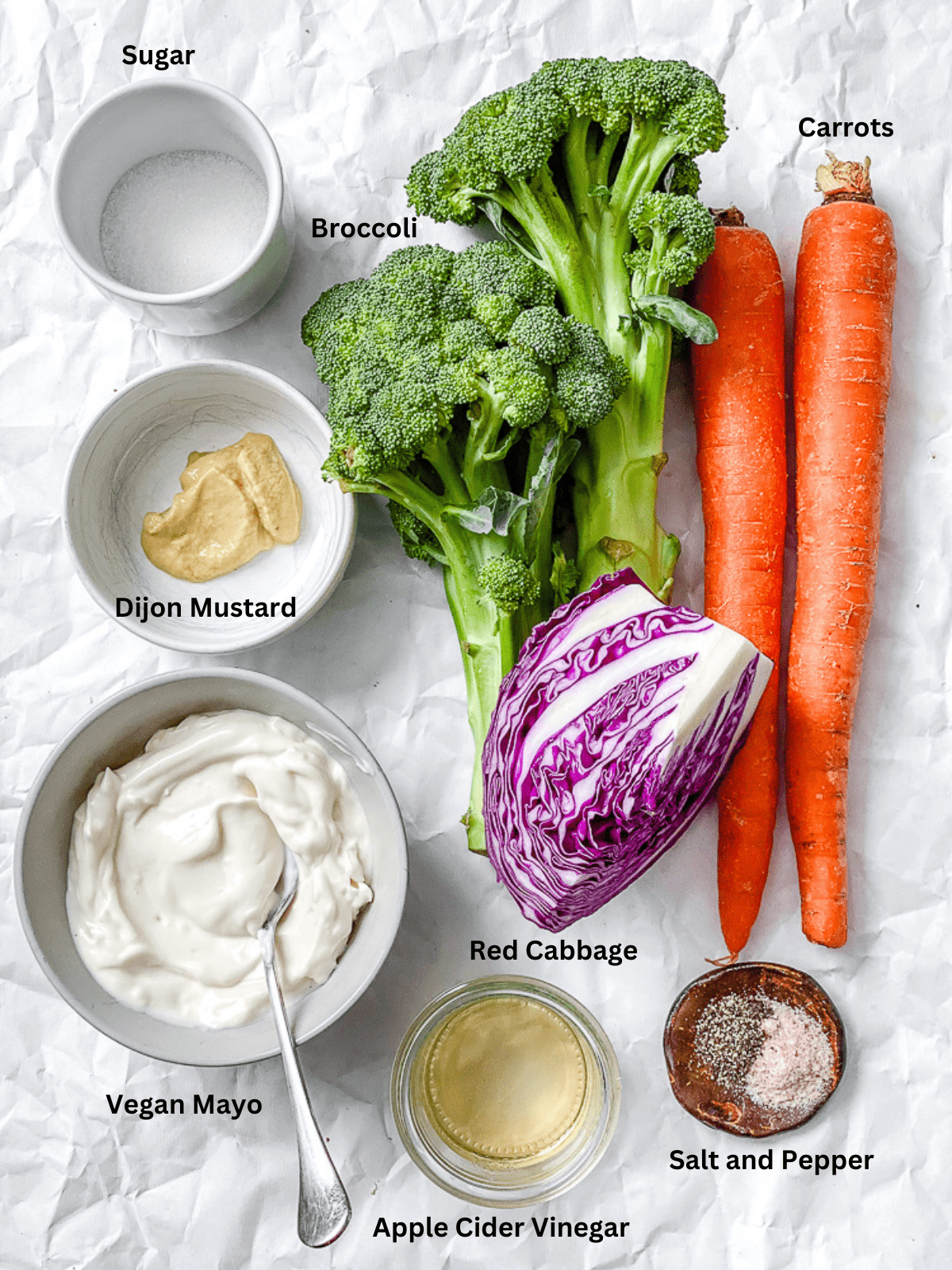 ingredients for Broccoli Slaw measured out on a white surface