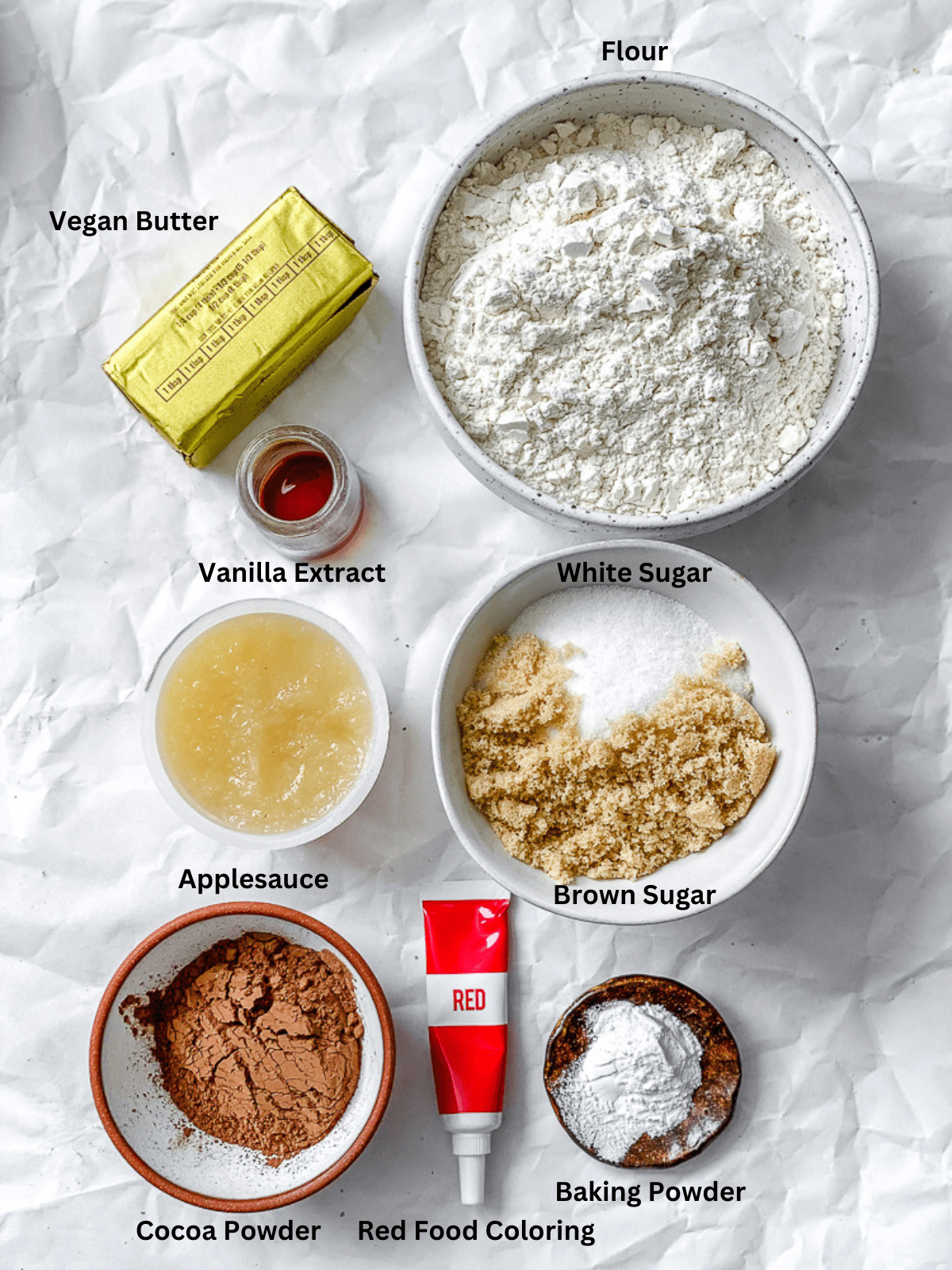 ingredients for Red Velvet Crinkle Cookies measured out on a white surface