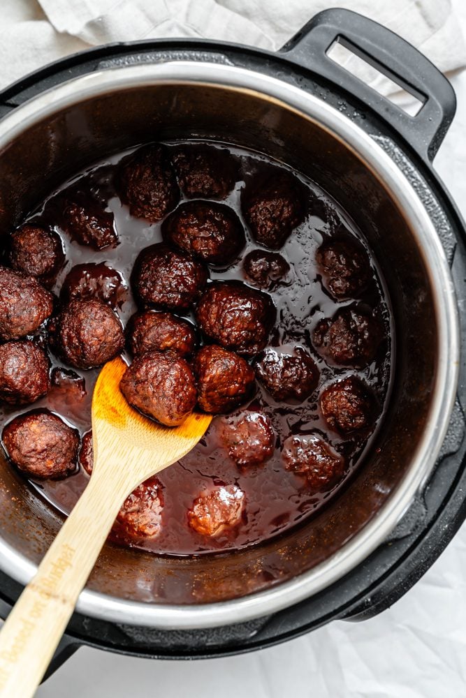 process shot showing stirring vegan meatballs in pot