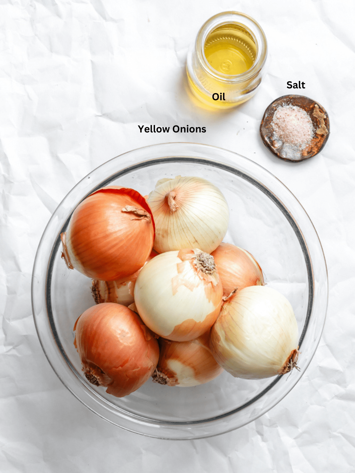 ingredients for The BEST Slow Cooker Caramelized Onions measured out on a white sruface