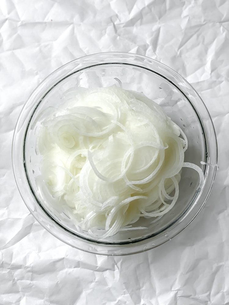 process shot showing cut up onions in a bowl