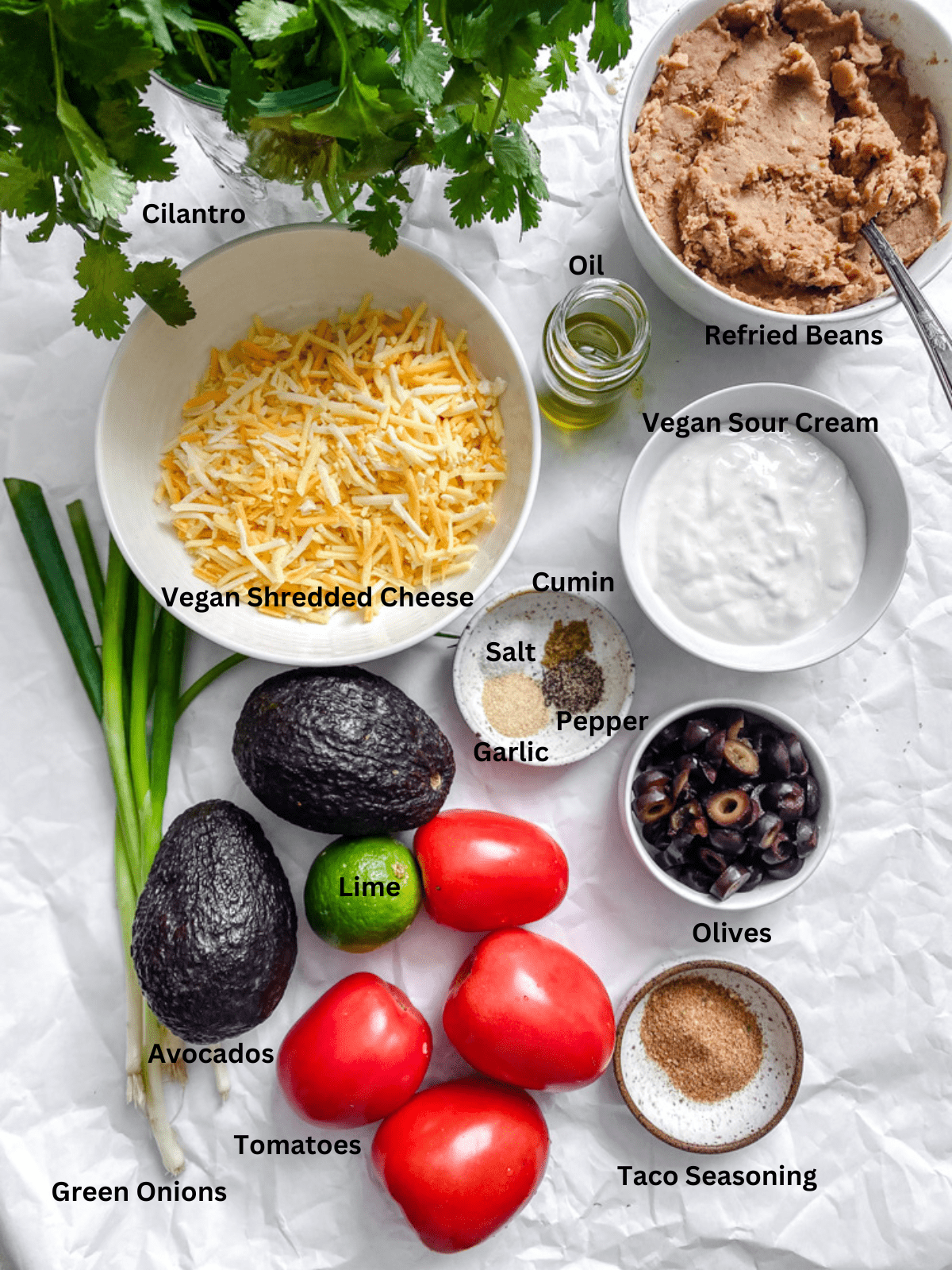 ingredients for Vegan 7 Layer Dip (Quick and Easy) measured out on a white surface