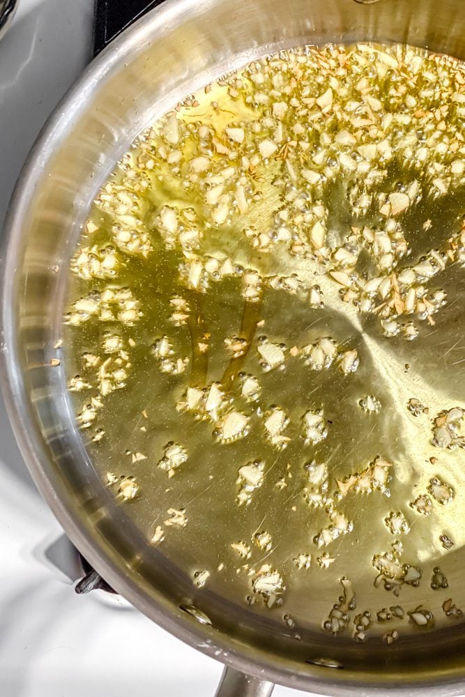 process shot showing garlic cooking in pot