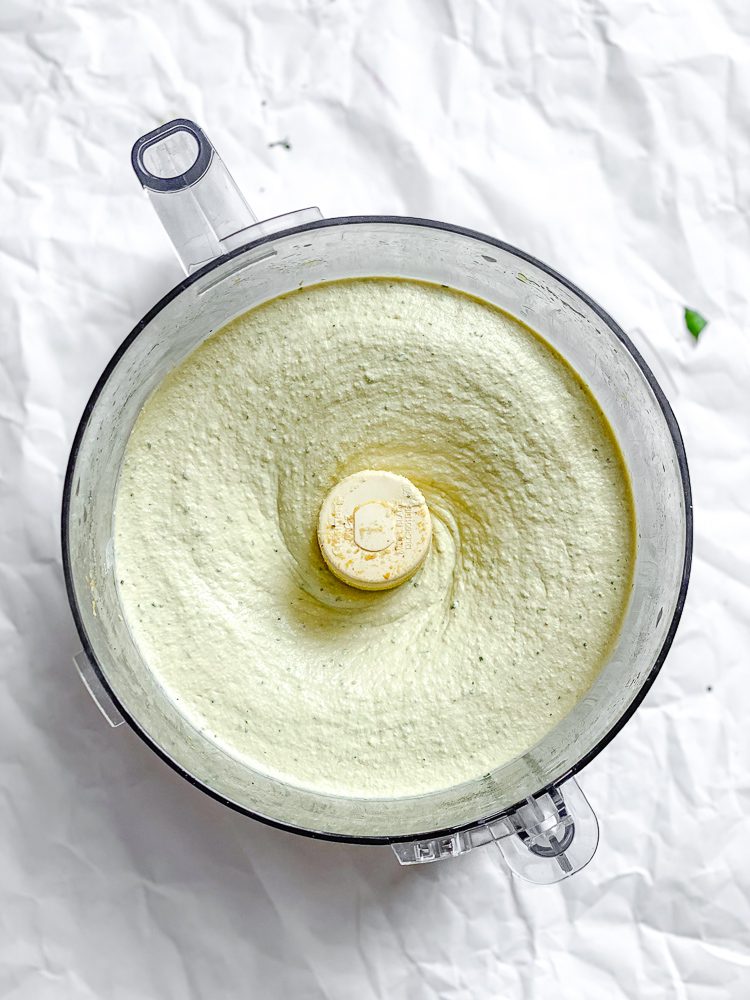 Process shot showing tofu ricotta in food processor.