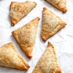 Process shot showing completed Vegan Apple Turnovers on a white surface.