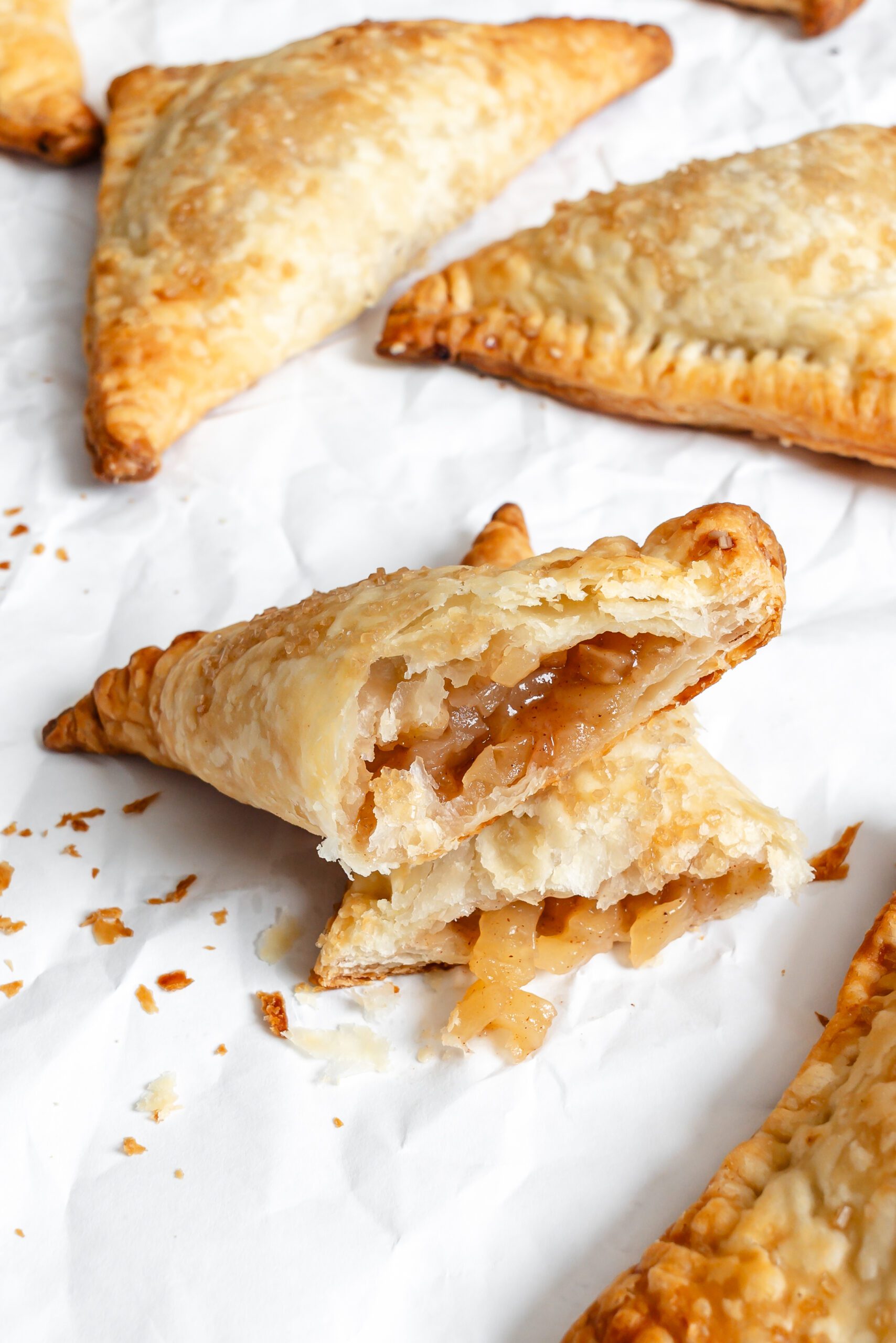 Process shot showing completed Vegan Apple Turnovers on a white surface.