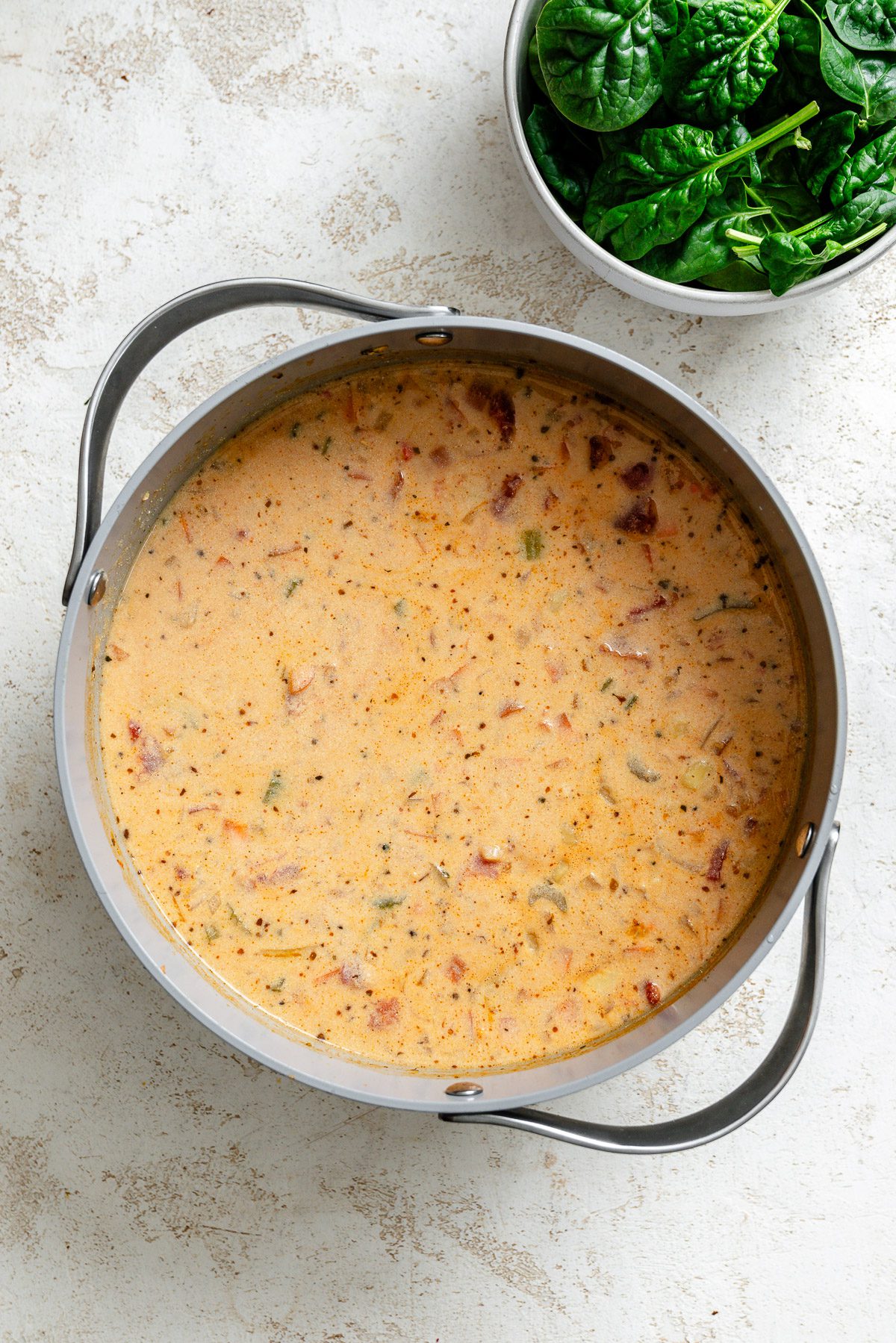 Process shot showing ingredients cooking in pot.
