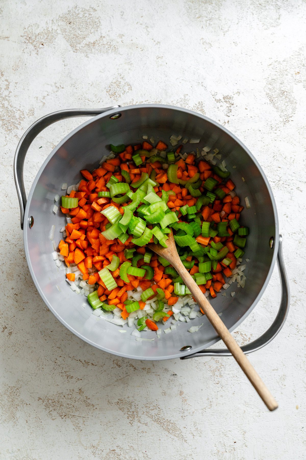 Process shot showing cooking veggies in a pot.
