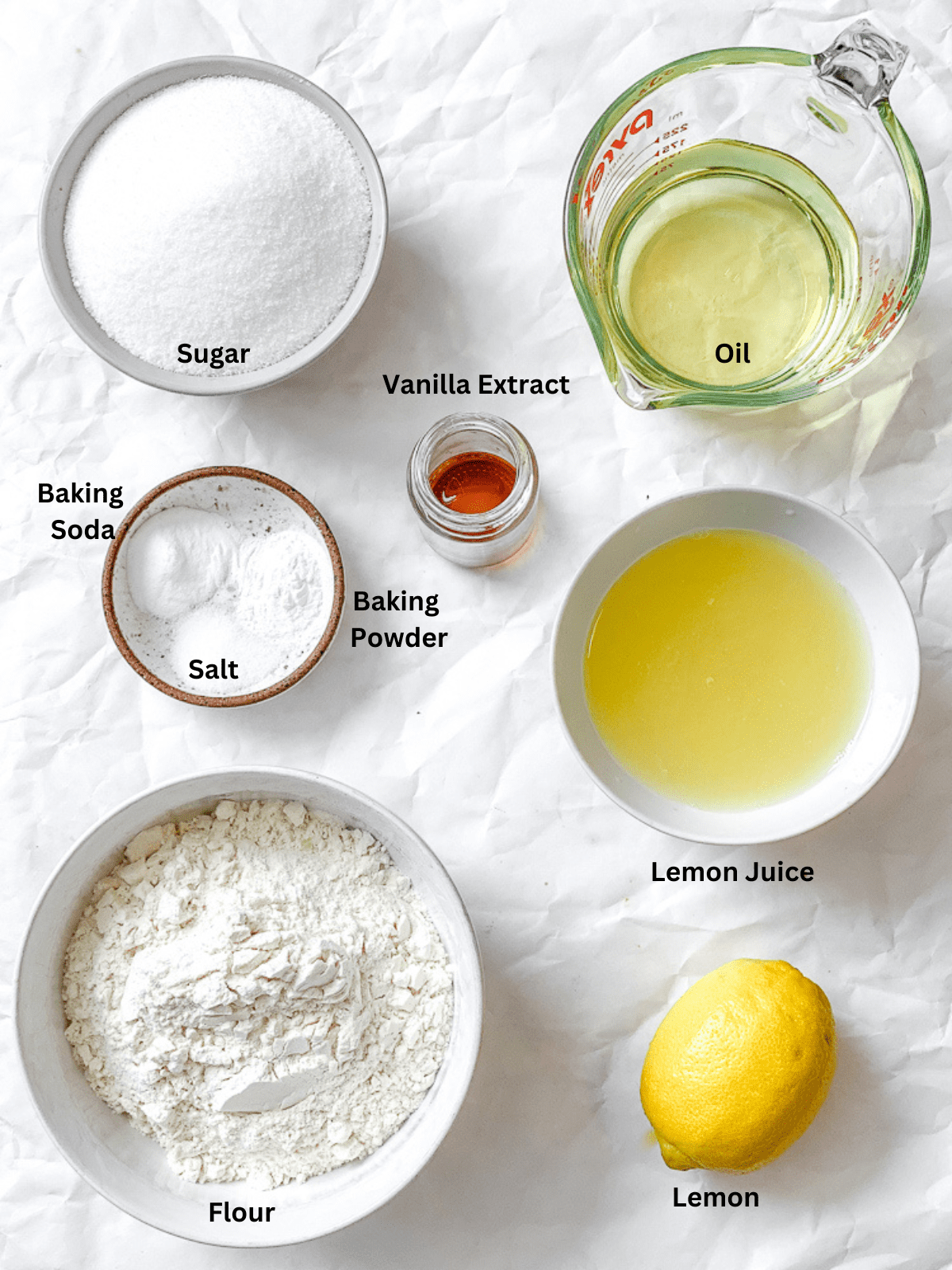 Ingredients for Lemon Olive Oil Cake (Vegan) measured out on a white surface.