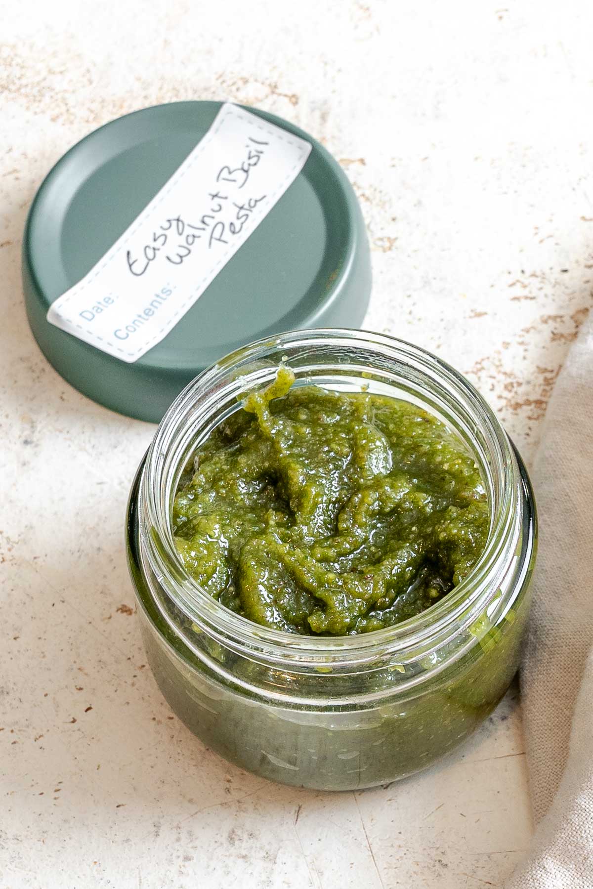 Completed Easy Walnut Pesto in a storage container.