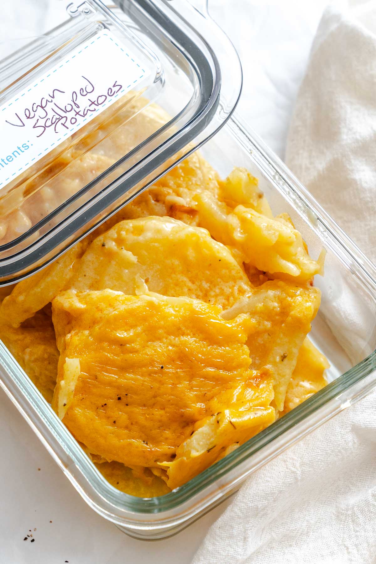 Completed Vegan Scalloped Potatoes in a storage container.
