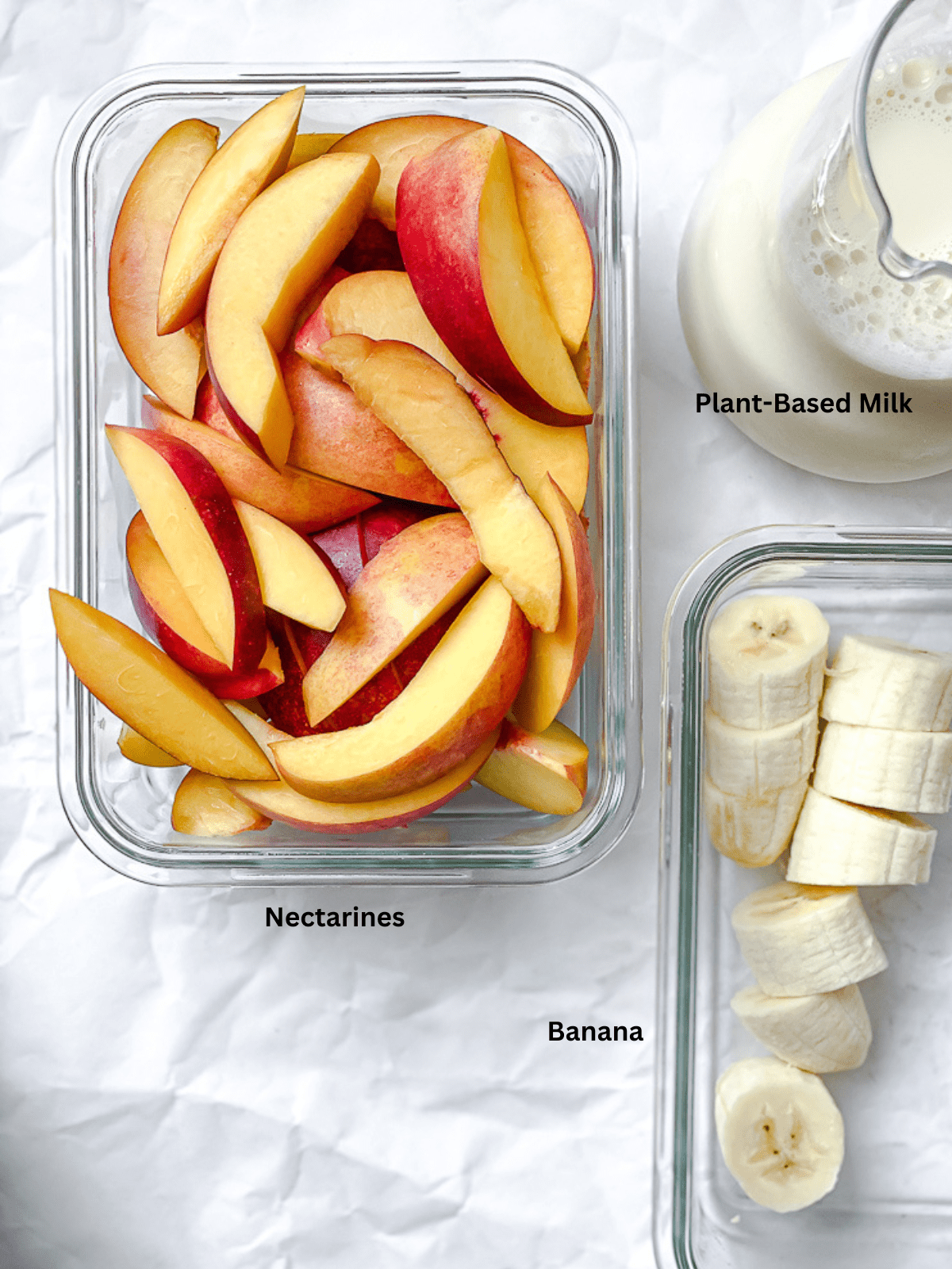 Ingredients for Banana Peach Smoothie measured out on a white surface.