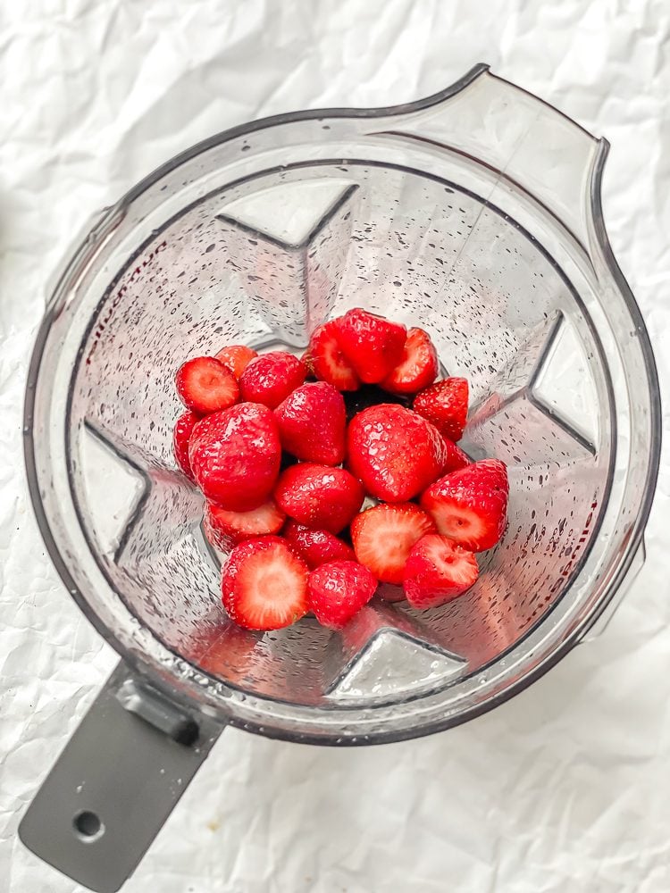 Process shot showing ingredients in blender.