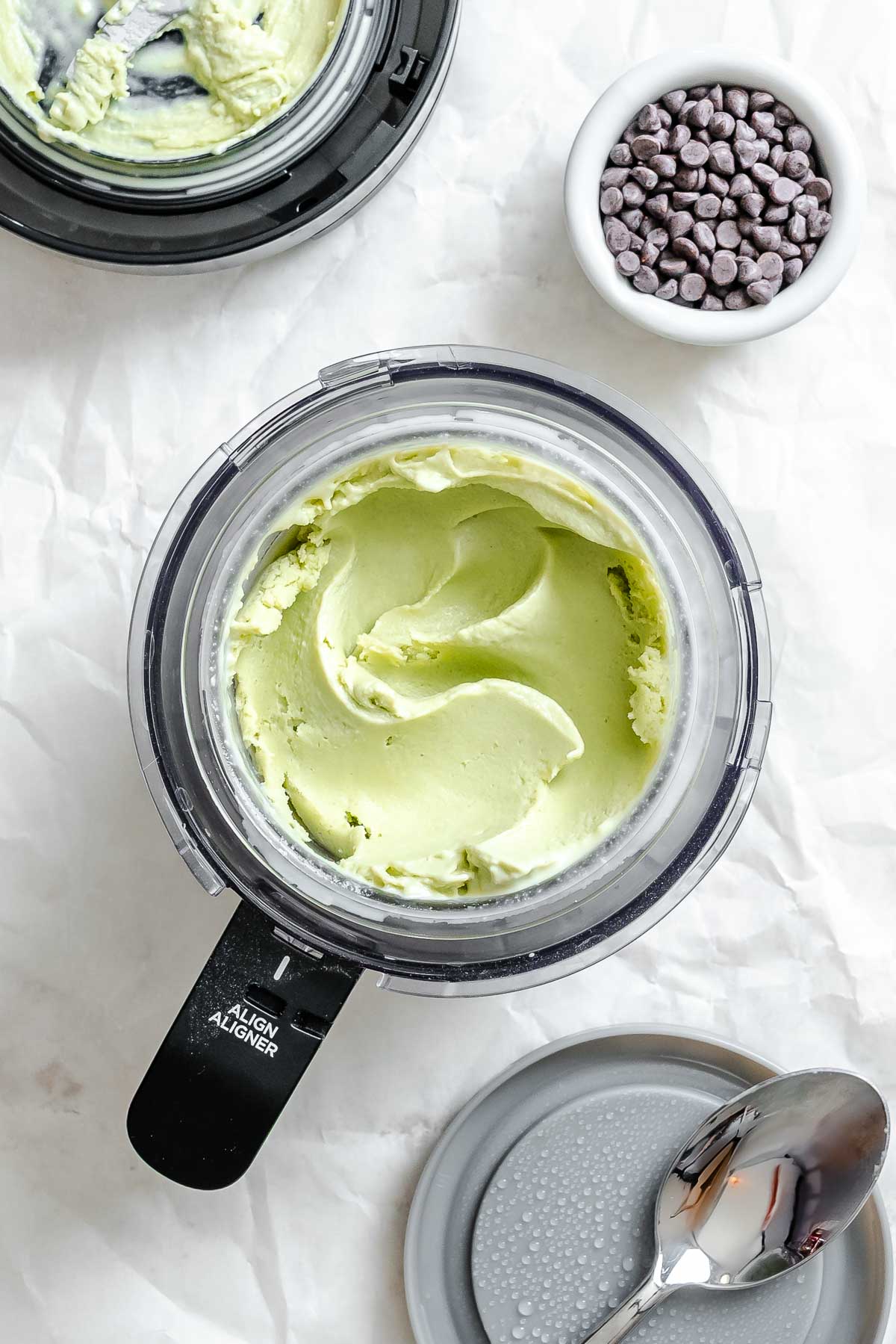 Process shot showing ingredients for Vegan Mint Chocolate Chip Ice Cream (Ninja Creami) in Ninja Creami.