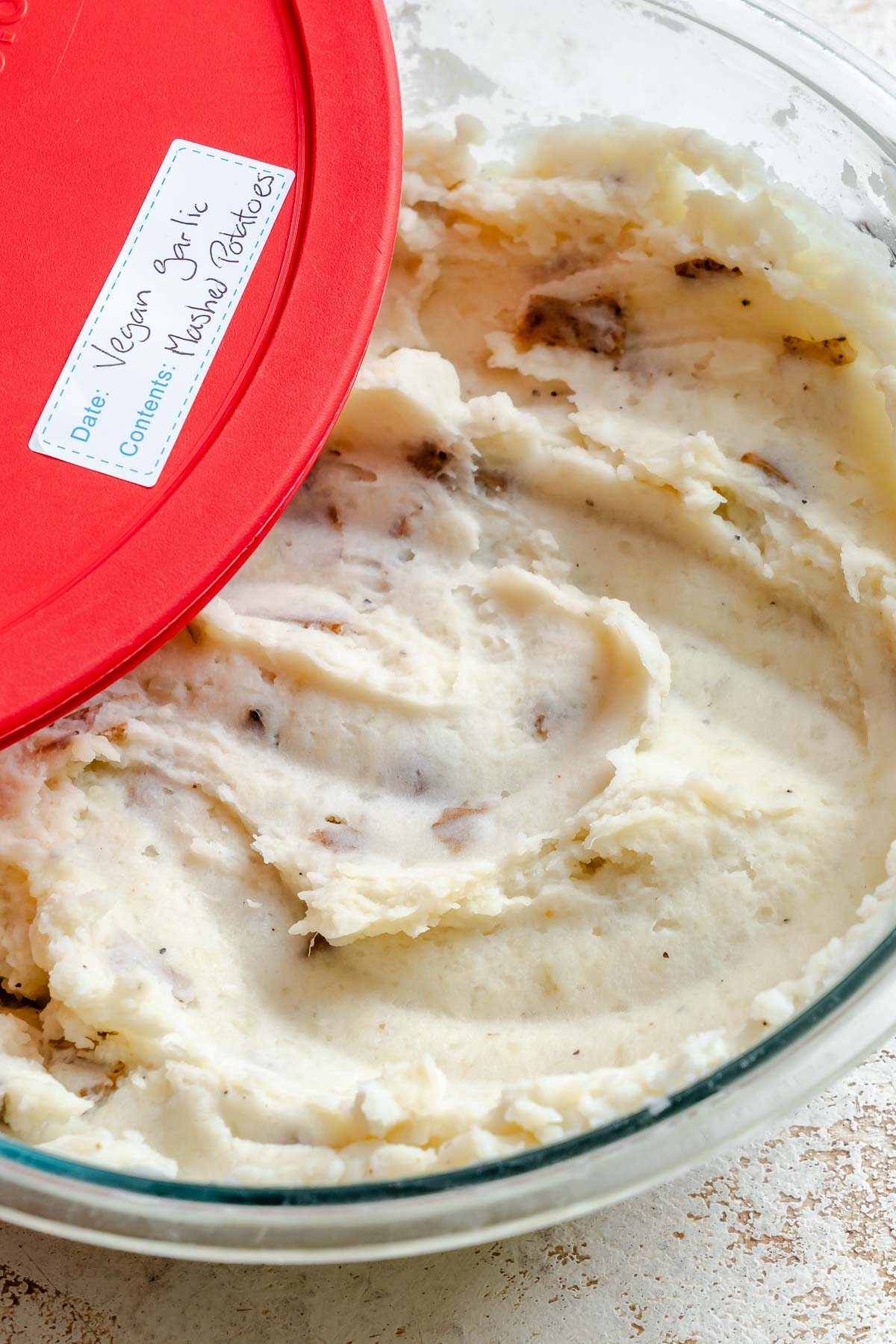 Completed vegan garlic mashed potatoes in a storage container.